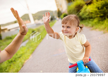 Father and daughter on motorbike in park Father and daughter on motorbike in park 20379997