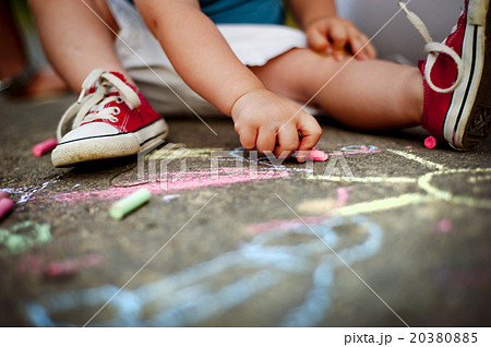 Close up of boy drawing with chalks Close up of boy drawing with chalks 20380885
