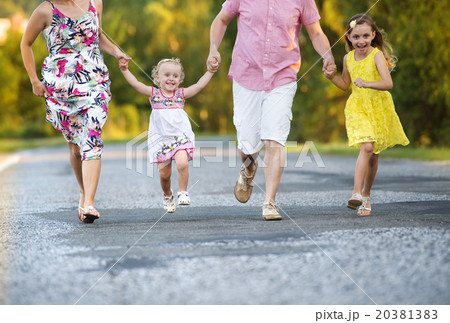 Happy family walking on road Happy family walking on road 20381383