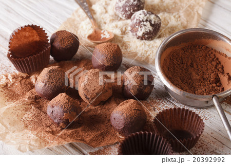 chocolate truffles sprinkled with cocoa and nut 20392992