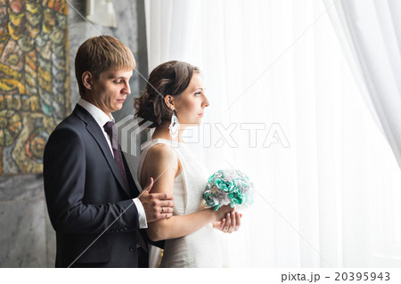 beautiful bride and groom near the window. 20395943