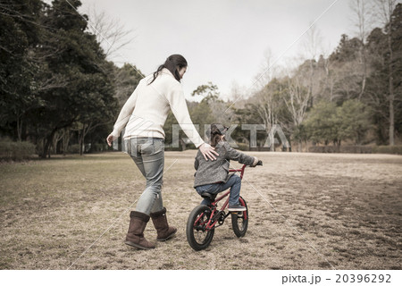 自転車の練習をする親子の写真素材