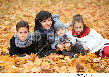 family in autumn park on yellow leaves 20396992