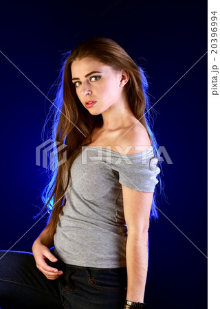 Young girl posing on blue backlight background 20396994