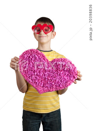 Cute boy in red glasses with pink paper heart Cute boy in red glasses with pink paper heart 20398836