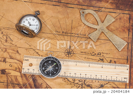 Old style brass pocket watch and cross on map 20404184