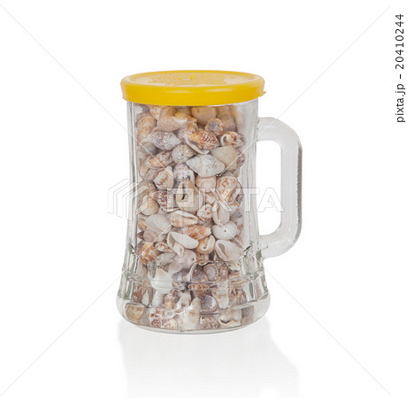 Old jar filled with small seashells 20410244
