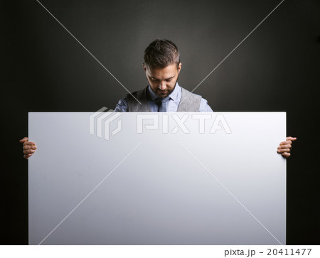Hipster businessman with blank advertisement Hipster businessman with blank advertisement 20411477
