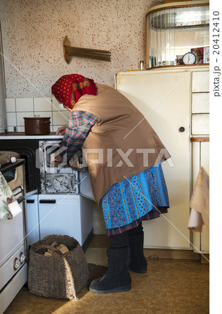 Old woman in the kitchen Old woman in the kitchen 20412410