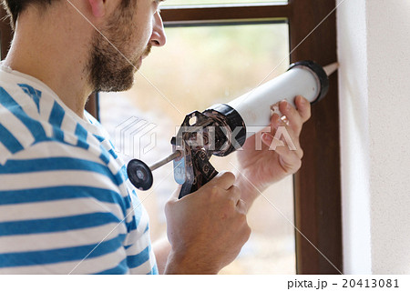 Man with caulking gun Man with caulking gun 20413081