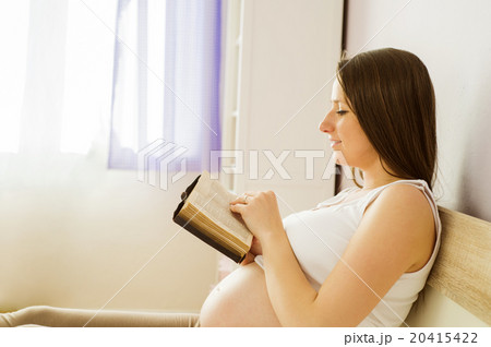Pregnant woman with book 20415422