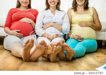 Pregnant women on sofa Pregnant women on sofa 20415797