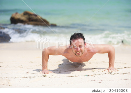 Man exercising on the beach Man exercising on the beach 20416008