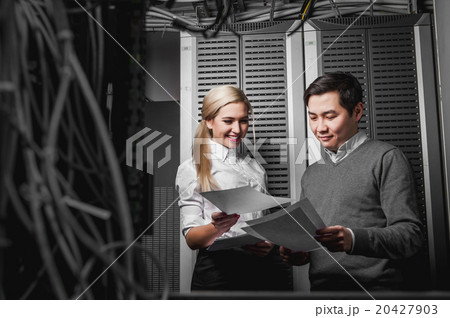 Young engineers businessmen in server room 20427903