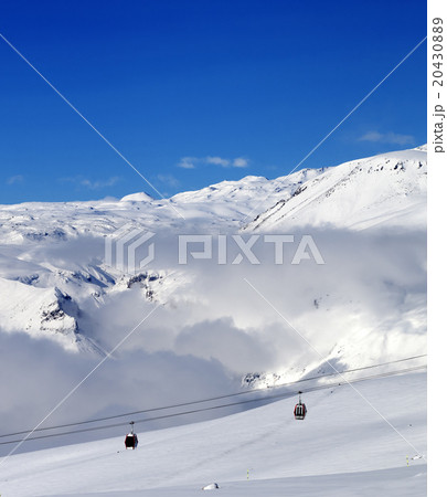 Off-piste snowy slope and cable car at sun day 20430889