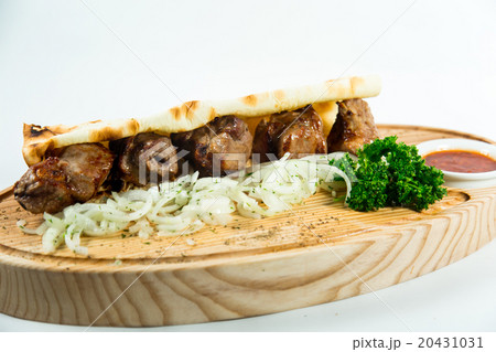 Beautiful juicy kebab in lavash with onion  20431031