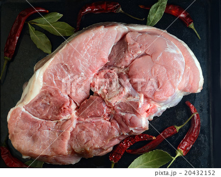 raw meat on a black background with spices 20432152
