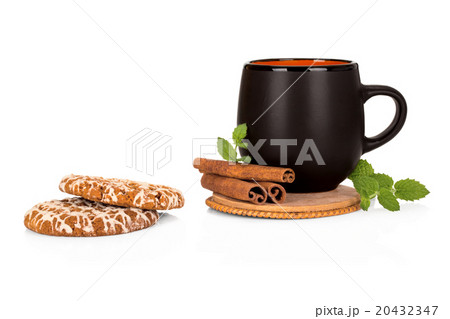 Black tea cup with cinnamon and cookies on white Black tea cup with cinnamon and cookies on white 20432347