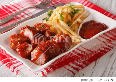 Currywurst sausage with french fries close-up Currywurst sausage with french fries close-up 20433319