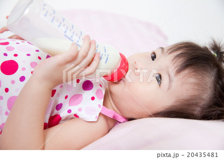 Beautiful little asian girl lying and suck up milk 20435481