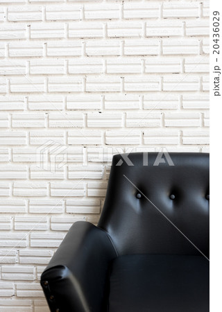 Close up classic black sofa and white brick wall Close up classic black sofa and white brick wall 20436029