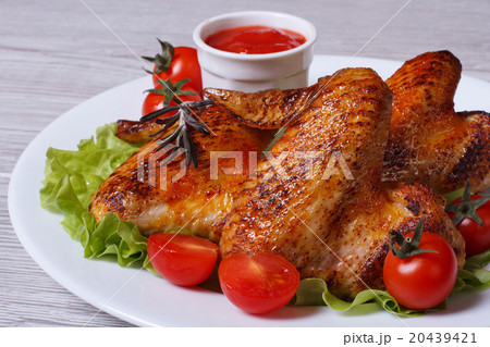 Juicy fried chicken wings with sauce 20439421