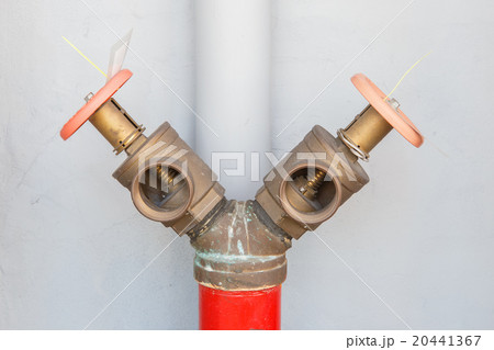 Fire hydrant with valve on concrete background. 20441367