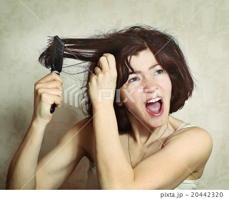 woman try to comb hairs woman try to comb hairs 20442320