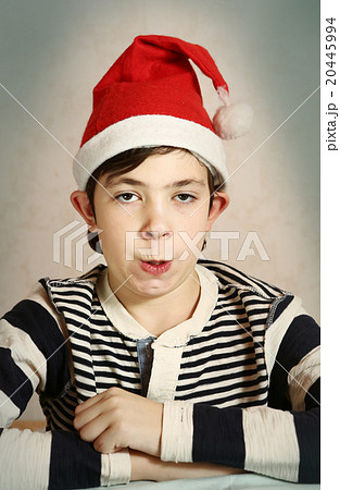 close up portrait of a preteen boy in santa hat close up portrait of a preteen boy in santa hat 20445994