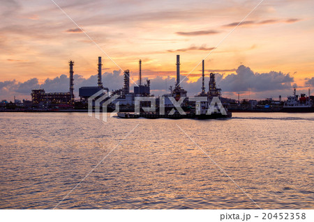 Oil refinery factory in silhouette and sunrise sky Oil refinery factory in silhouette and sunrise sky 20452358