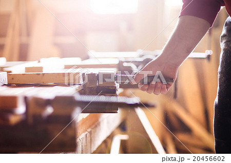 Carpenter gluing wooden planks Carpenter gluing wooden planks 20456602