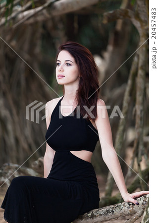 woman in a black dress woman in a black dress 20457483