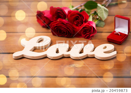 close up of diamond ring, red roses and word love close up of diamond ring, red roses and word love 20459873