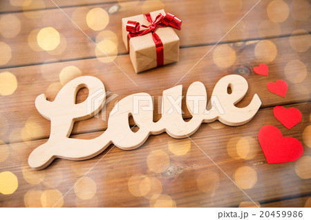close up of word love with gift box and red hearts 20459986