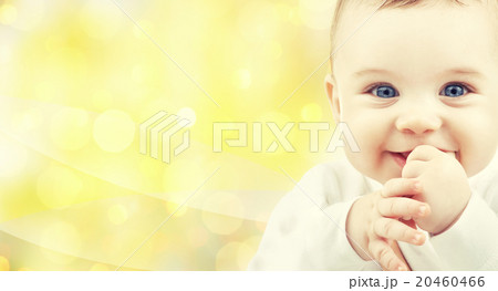 close up of happy baby over yellow background 20460466