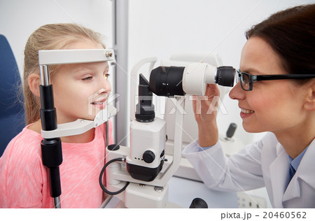 optician with tonometer and patient at eye clinic optician with tonometer and patient at eye clinic 20460562