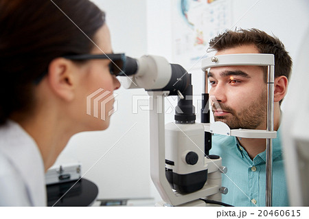 optician with tonometer and patient at eye clinic optician with tonometer and patient at eye clinic 20460615