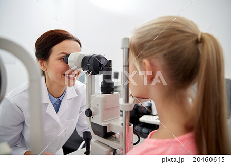 optician with tonometer and patient at eye clinic optician with tonometer and patient at eye clinic 20460645