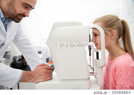 optician with tonometer and patient at eye clinic optician with tonometer and patient at eye clinic 20460664
