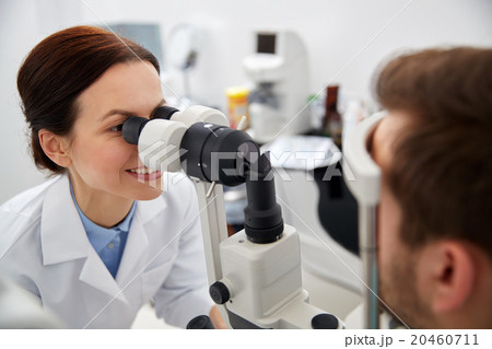 optician with tonometer and patient at eye clinic optician with tonometer and patient at eye clinic 20460711