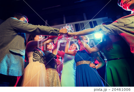 smiling friends with glasses of champagne in club smiling friends with glasses of champagne in club 20461006