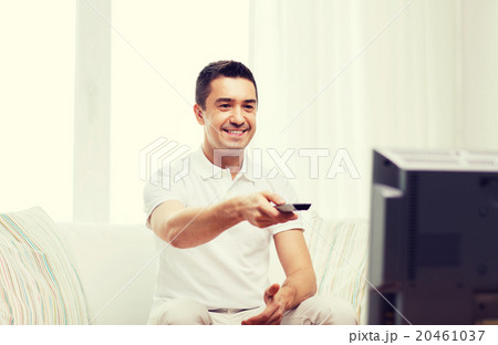 smiling man with remote control watching tv smiling man with remote control watching tv 20461037