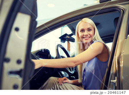 happy woman inside car in auto show or salon 20461147