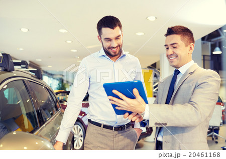 happy man with car dealer in auto show or salon happy man with car dealer in auto show or salon 20461168