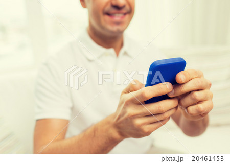 close up of happy man with smartphone at home close up of happy man with smartphone at home 20461453