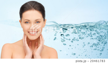 smiling young woman touching her face 20461783