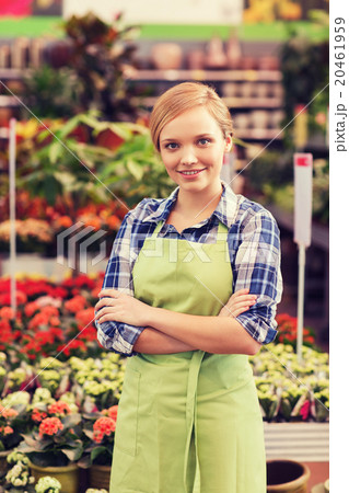 happy woman with flowers in greenhouse 20461959