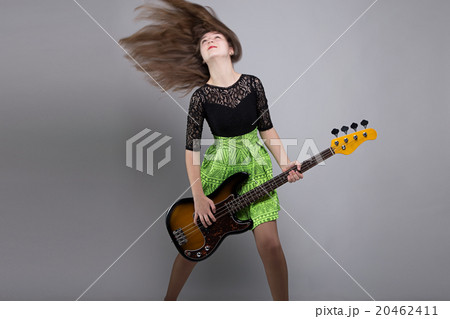 Teenage girl with guitar, shaked head Teenage girl with guitar, shaked head 20462411