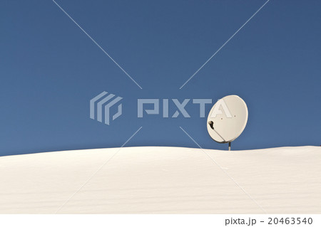 Sattelite antenna on snowy roof. 20463540