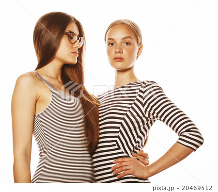 two young workers isolated on white, same dresses 20469512